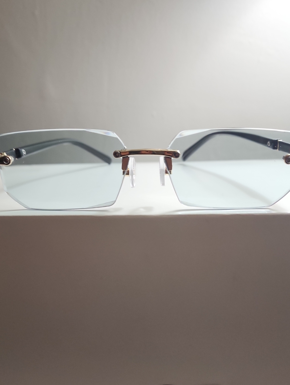 Gold and Black Rimless Sunglasses with Light Blue Lenses